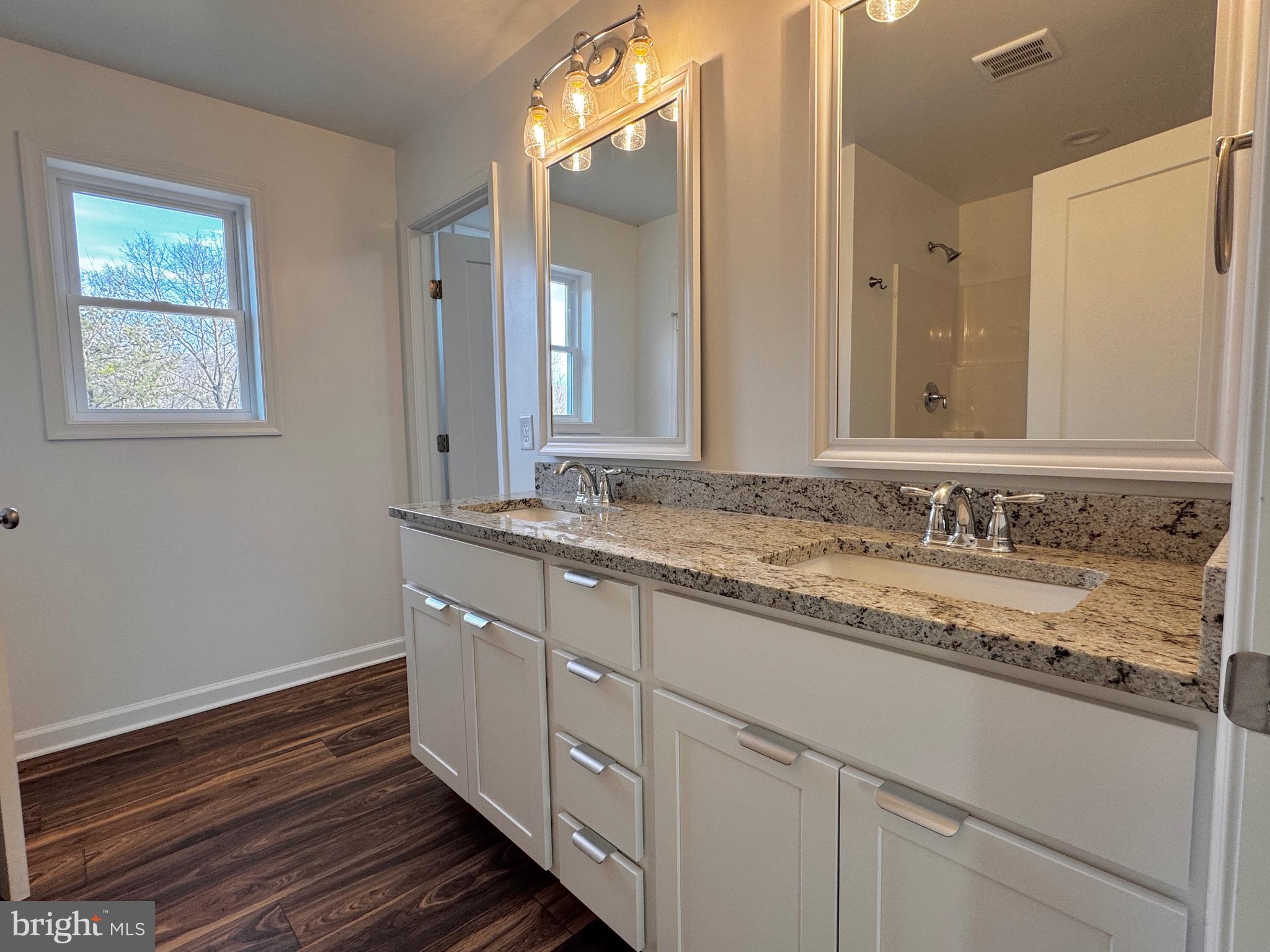 1241 Pine Grove Road Berkeley Springs, WV 25411 - Photo 12 of 19 a bathroom with a granite countertop sink and a mirror