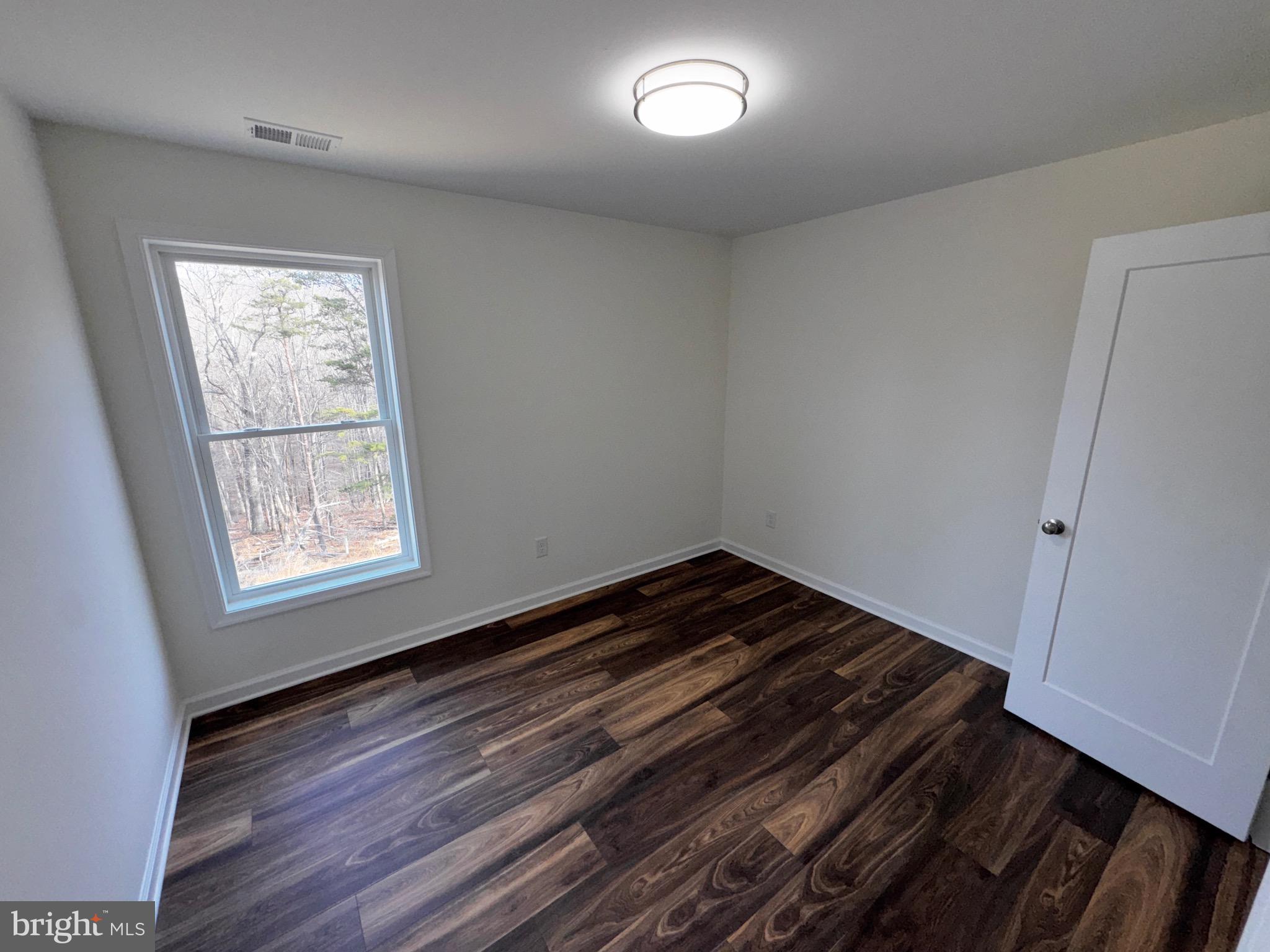 1241 Pine Grove Road Berkeley Springs, WV 25411 - Photo 16 of 19 a view of empty room with wooden floor