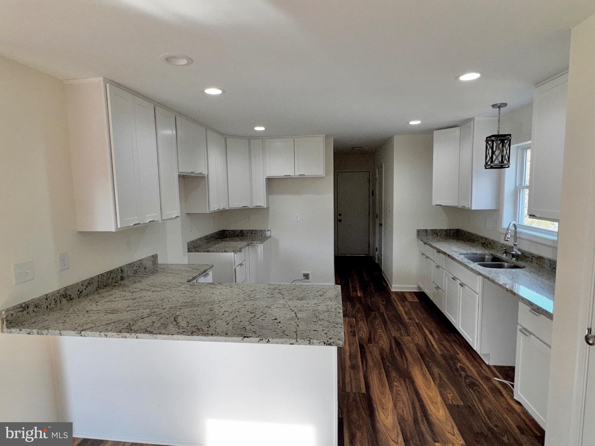1241 Pine Grove Road Berkeley Springs, WV 25411 - Photo 7 of 19 a large kitchen with stainless steel appliances granite countertop a granite counter tops and a stove