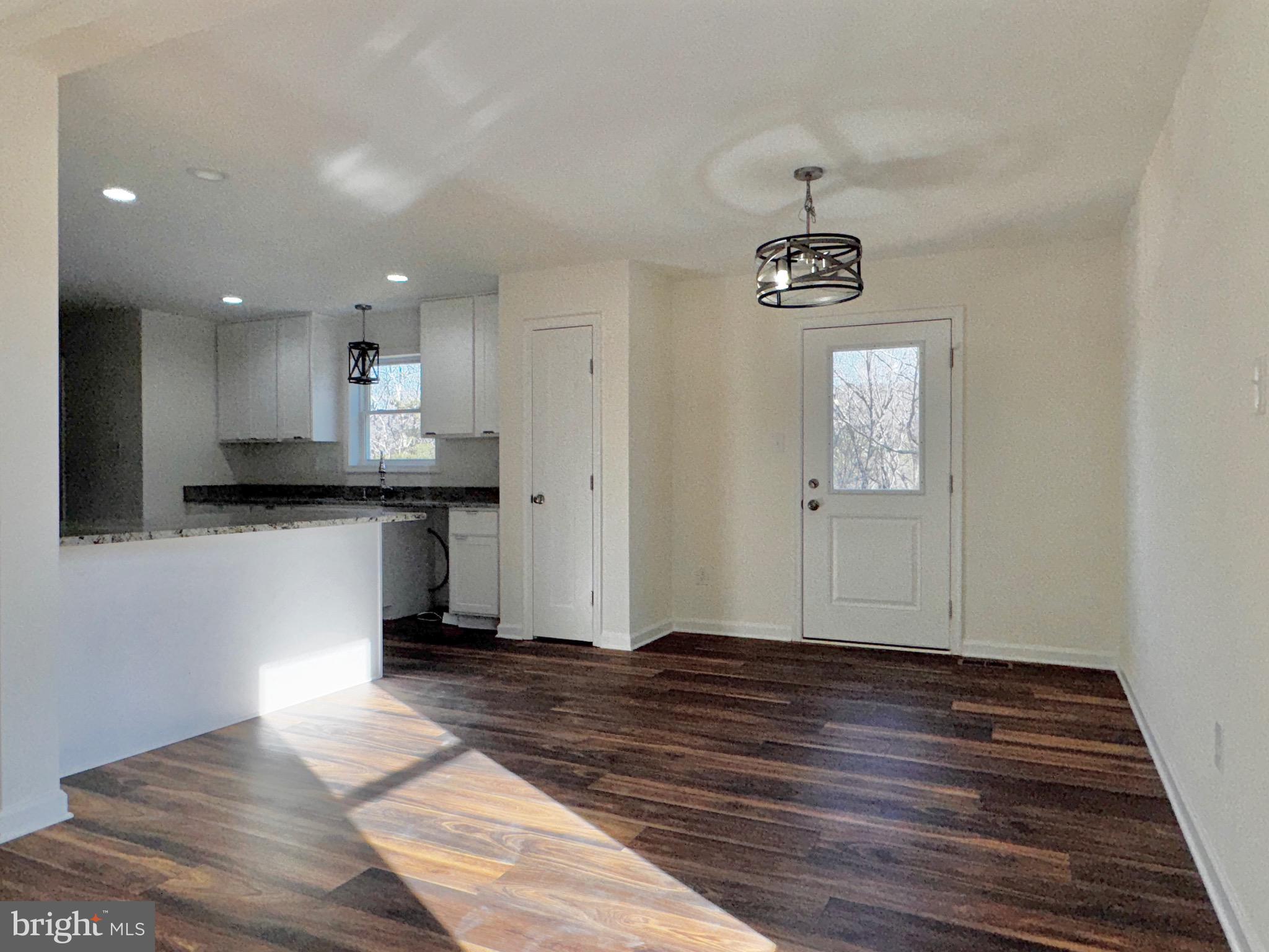 1241 Pine Grove Road Berkeley Springs, WV 25411 - Photo 8 of 19 a view of a kitchen with sink and wooden floor