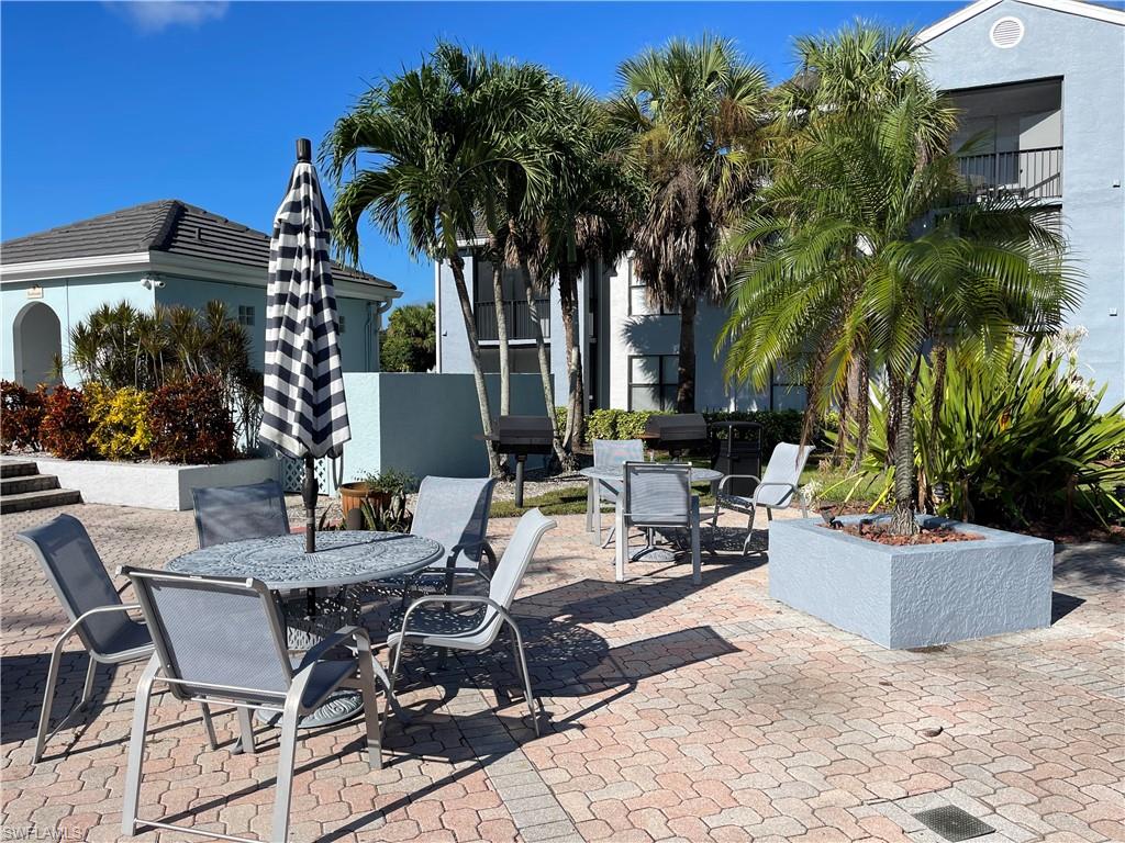 13521 Eagle Ridge Drive, Unit 133 Fort Myers, FL 33912 - Photo 12 of 15 a view of a dinning table and chair in the patio