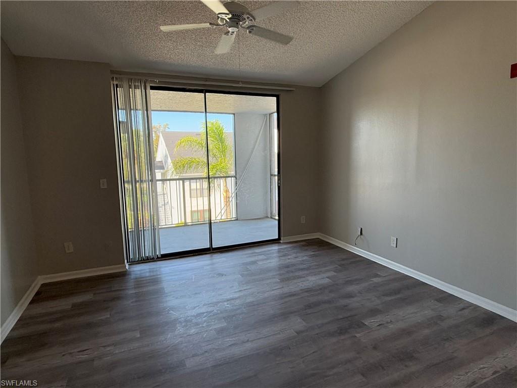 13521 Eagle Ridge Drive, Unit 133 Fort Myers, FL 33912 - Photo 2 of 15 an empty room with wooden floor and windows