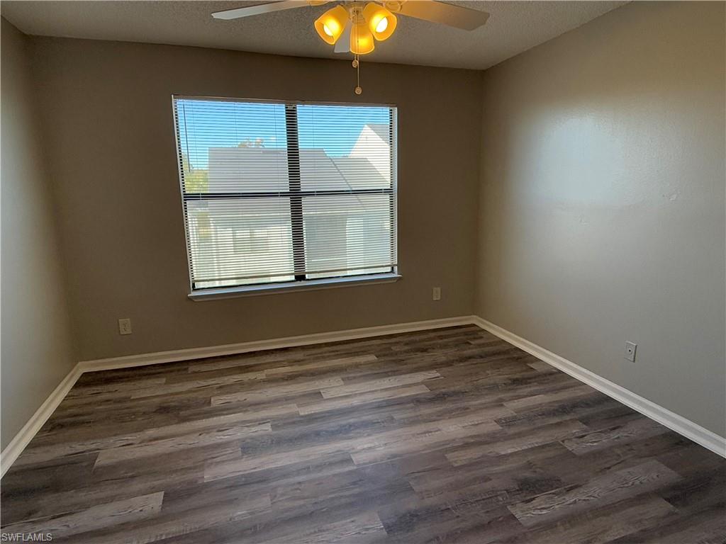 13521 Eagle Ridge Drive, Unit 133 Fort Myers, FL 33912 - Photo 4 of 15 an empty room with wooden floor and windows