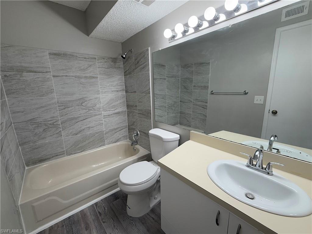 13521 Eagle Ridge Drive, Unit 133 Fort Myers, FL 33912 - Photo 7 of 15 a bathroom with a sink toilet and shower