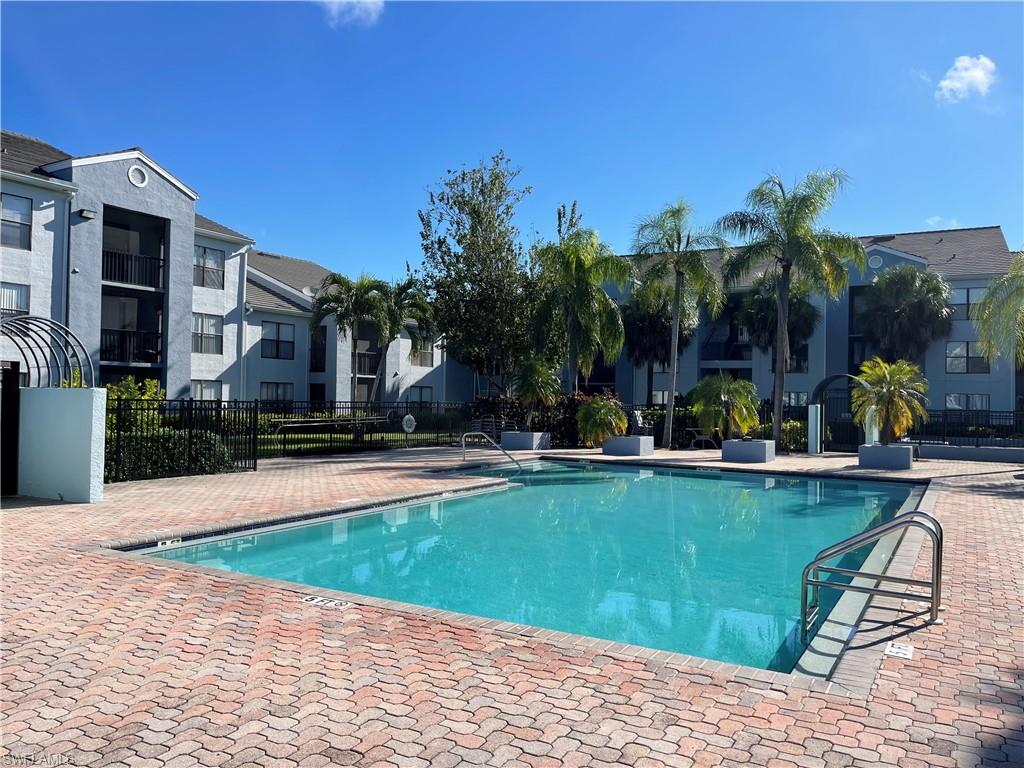 13521 Eagle Ridge Drive, Unit 133 Fort Myers, FL 33912 - Photo 9 of 15 a view of a swimming pool with lounge chairs
