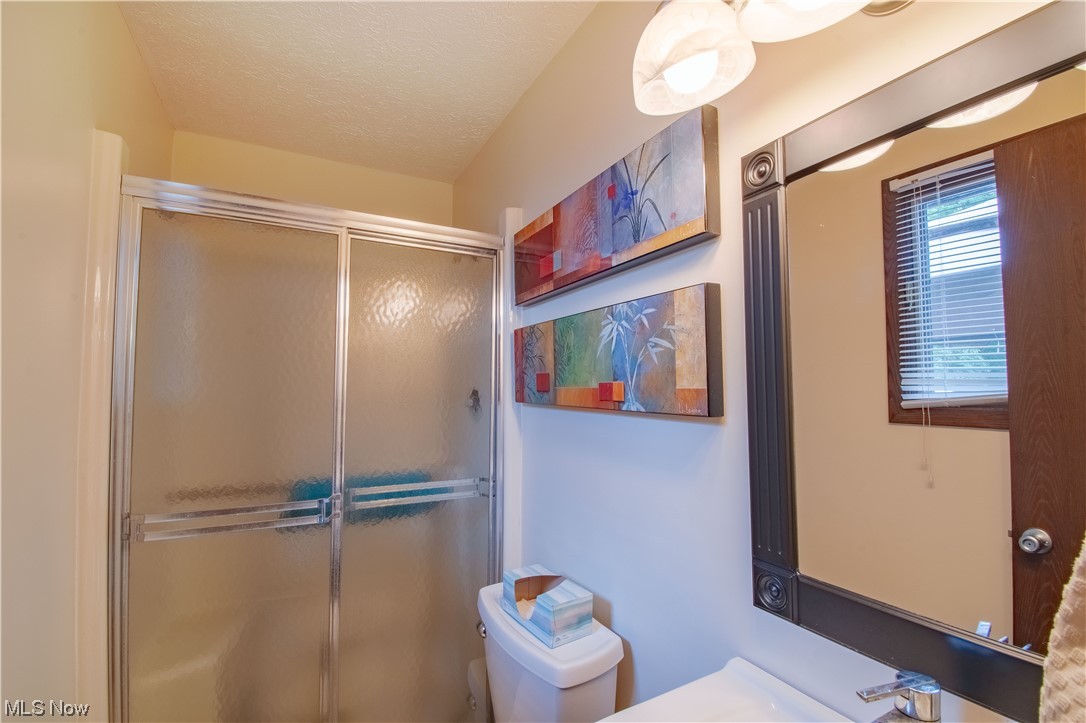 241 Ridge Road Mogadore, OH 44260 - Photo 23 of 26 a private master bath featuring a walk-in shower, and a vanity with storage.