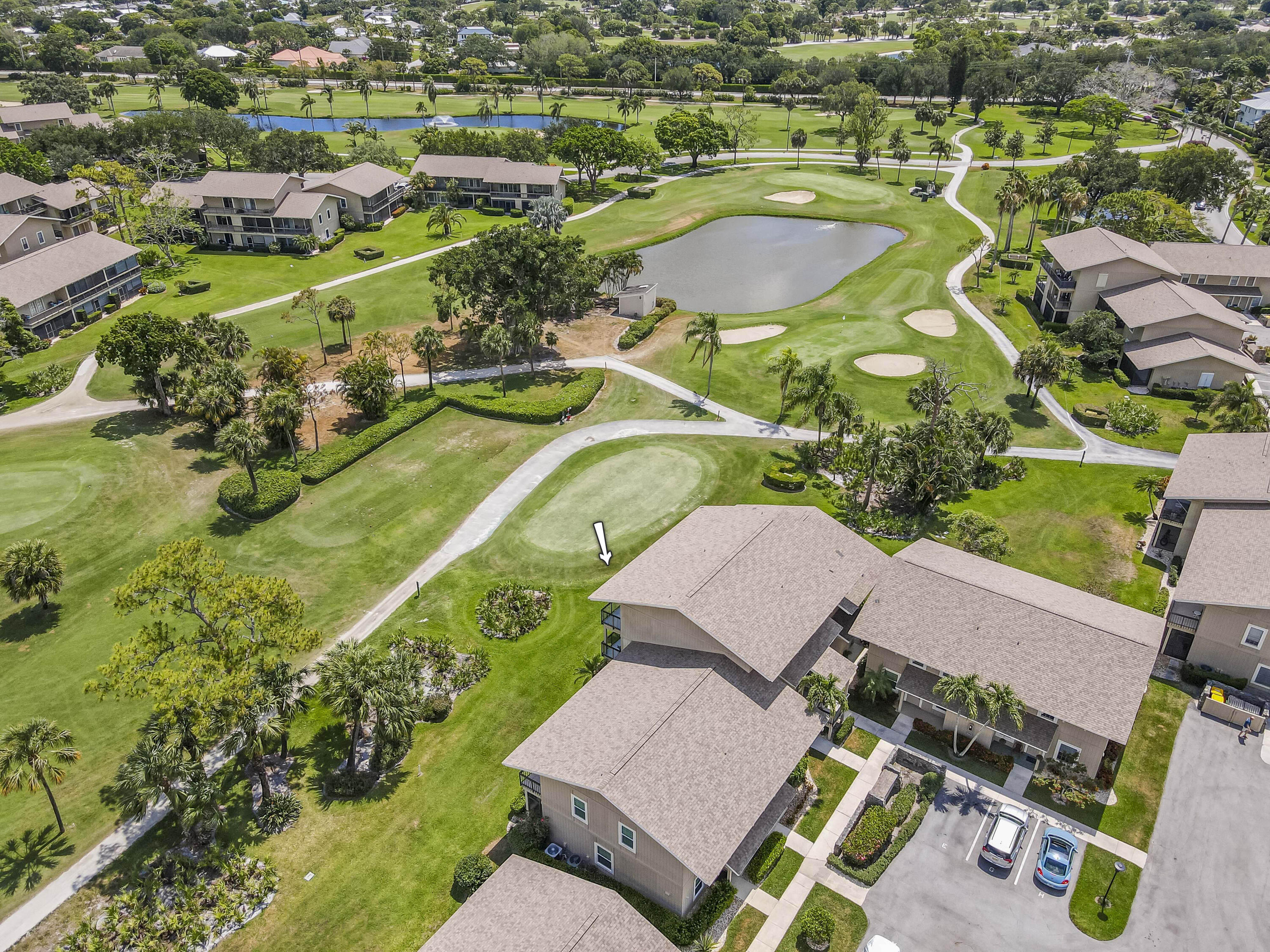 9239 Southeast Riverfront Terrace, Unit D Jupiter, FL 33469 - Photo 22 of 33 an aerial view of a house with a swimming pool yard and mountain view in back