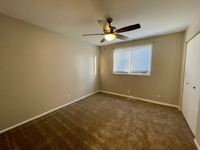 355 Pearson Circle Naperville, IL 60563 - Photo 11 of 19 an empty room with a window and a fan