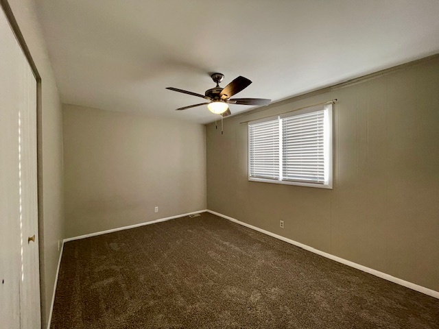 355 Pearson Circle Naperville, IL 60563 - Photo 7 of 19 an empty room with a ceiling fan and window