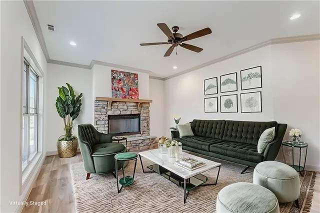 a view of a livingroom with a hardwood floor and a ceiling fan