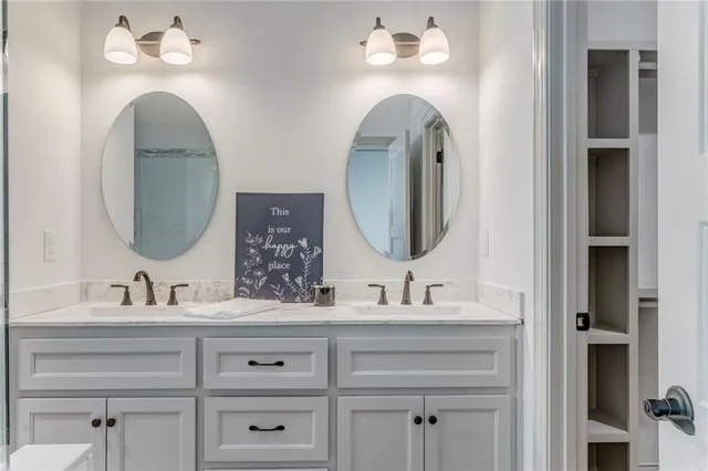 a kitchen with kitchen island granite countertop a sink cabinets and stainless steel appliances