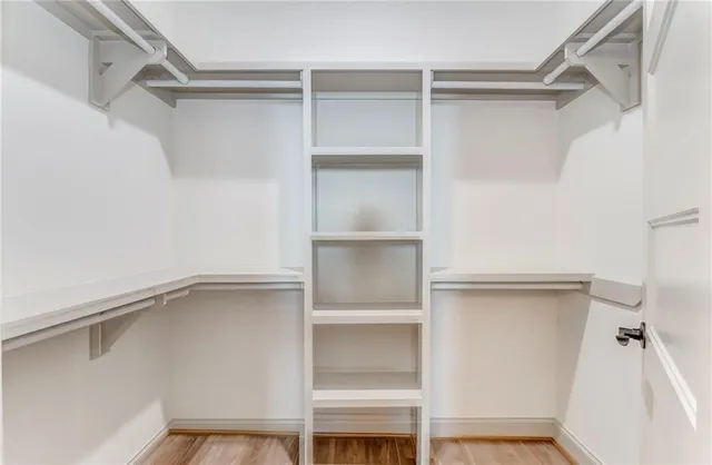 a kitchen with granite countertop white cabinets and stainless steel appliances