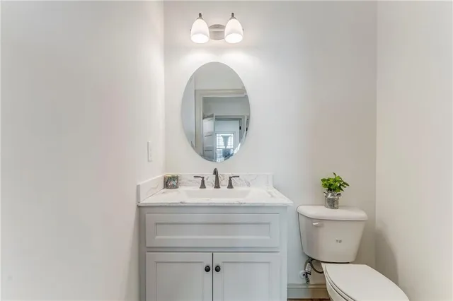 a kitchen with stainless steel appliances granite countertop a stove and a white cabinets