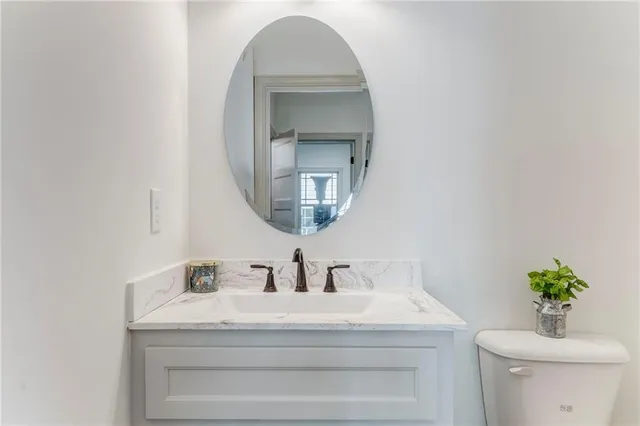 a kitchen with stainless steel appliances a sink dishwasher a refrigerator and a stove with wooden floor