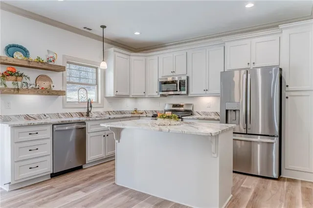 a bathroom with a sink vanity mirror and toilet