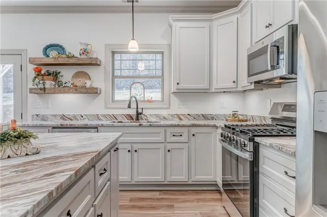 an empty room with fan and windows
