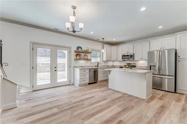 a front view of a house with a yard covered in snow