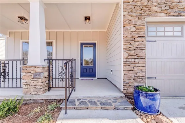 a view of an empty room with wooden floor fireplace and a window