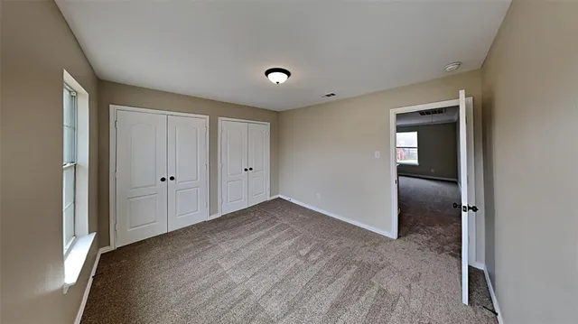 an empty room with closet area and closet