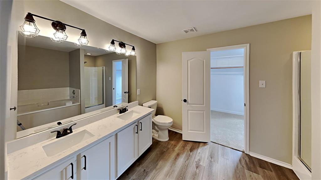 2203 Wagon Wheel Trail Corinth, TX 76208 - Photo 13 of 16 a bathroom with a double vanity sink a mirror and a shower
