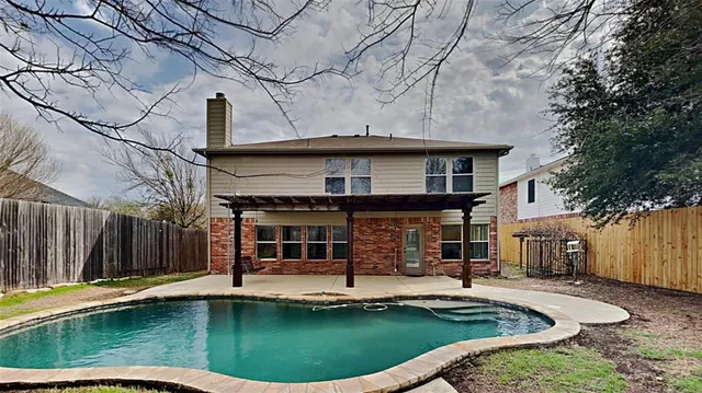 a view of a house with swimming pool and sitting area