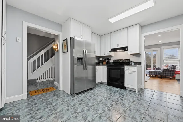 a living room with furniture a fireplace a flat screen tv and a large window