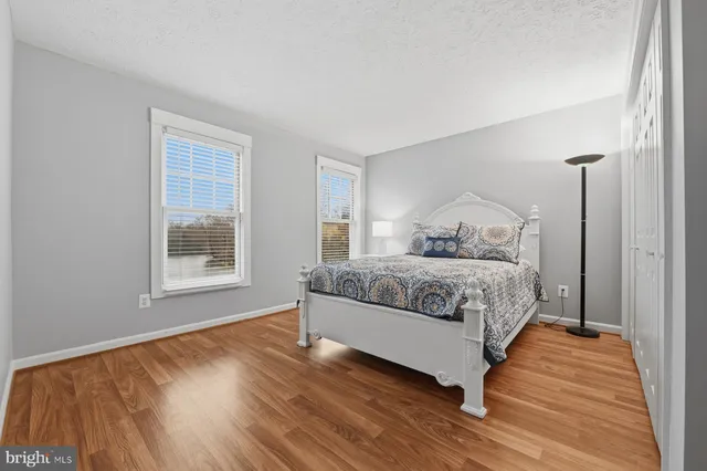 a spacious bathroom with a toilet a sink and mirror