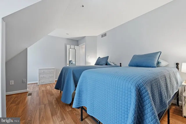a living room with furniture and a open kitchen view