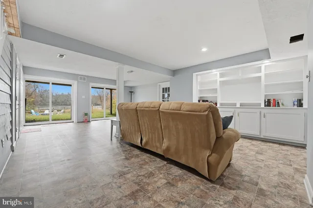 an aerial view of lake residential house with outdoor space and trees around