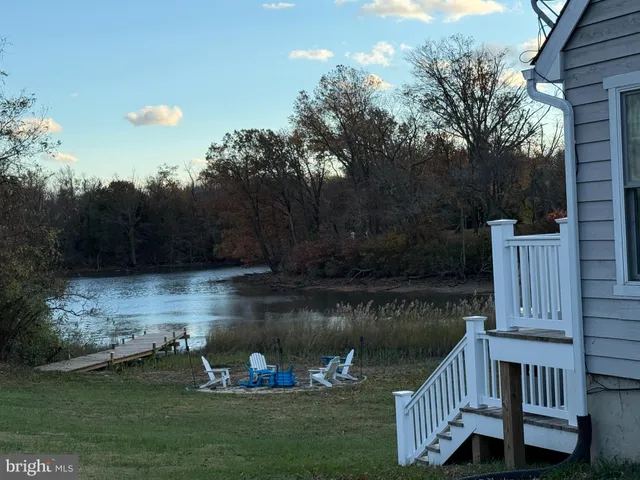 a kitchen with granite countertop a refrigerator sink and cabinets