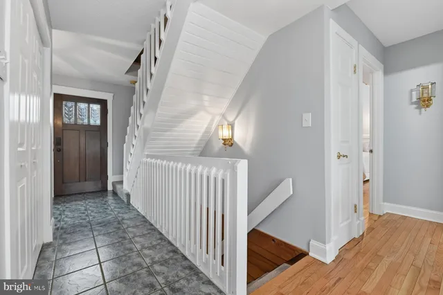 a living room with furniture wooden floor and a large window