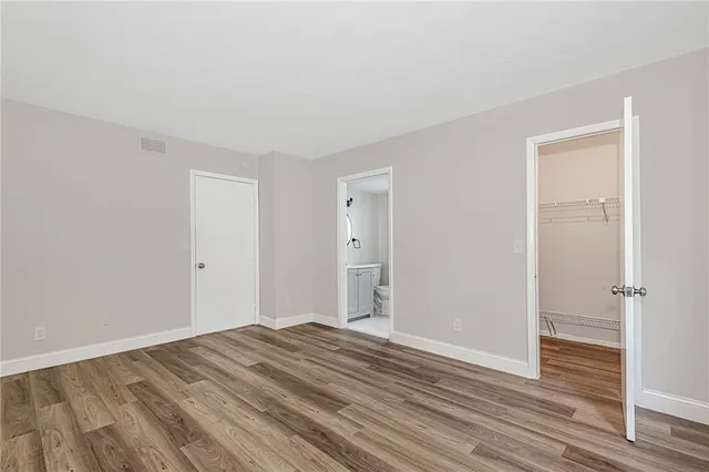 a view of a room with wooden floor and bathroom