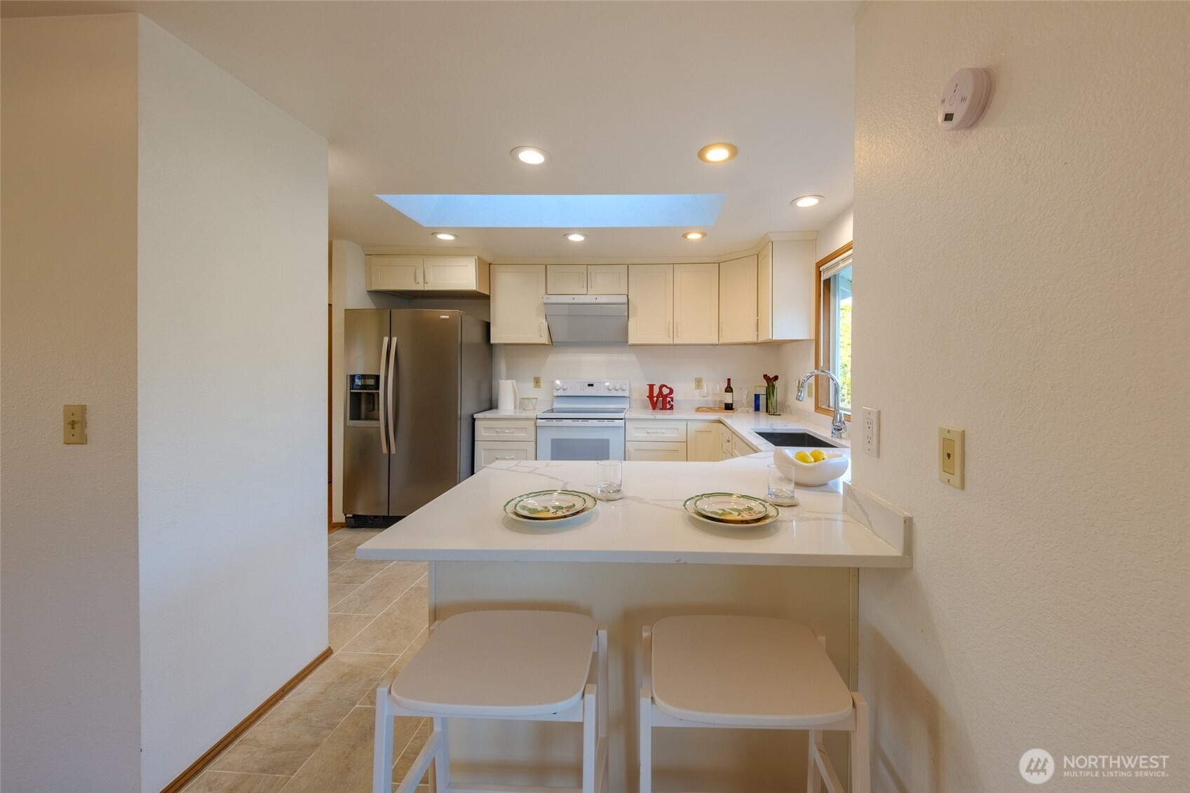 830 234th Street Southeast Bothell, WA 98021 - Photo 7 of 26 a kitchen with a refrigerator a stove a sink and cabinets
