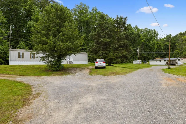 a view of a house with backyard and trees