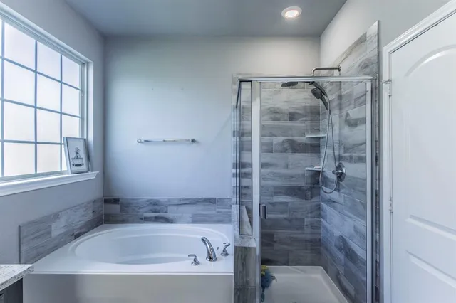 a bathroom with a shower and a bathtub