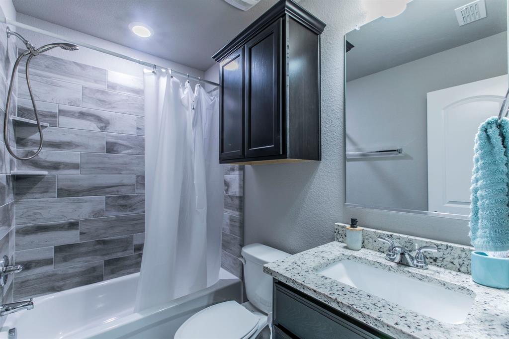 3113 Samson Drive Lorena, TX 76655 - Photo 15 of 25 a bathroom with a granite countertop sink toilet and shower