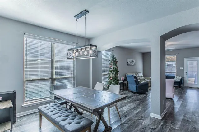 a view of a dining room with furniture wooden floor and chandelier