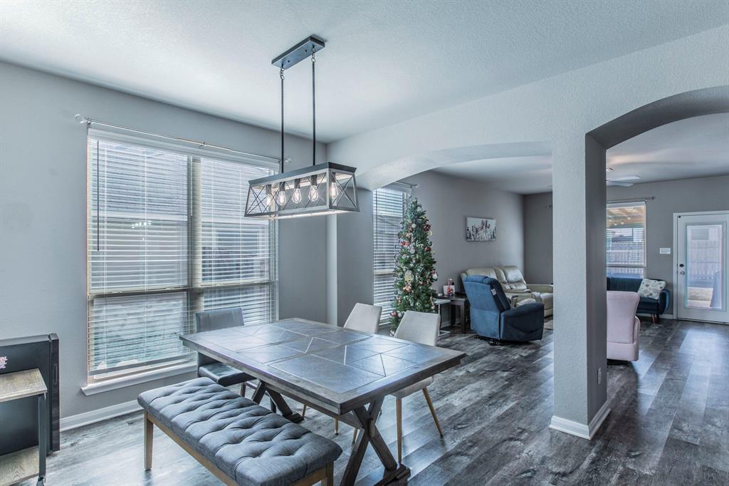 3113 Samson Drive Lorena, TX 76655 - Photo 2 of 25 a view of a dining room with furniture wooden floor and chandelier