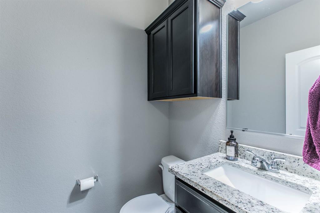 3113 Samson Drive Lorena, TX 76655 - Photo 21 of 25 a bathroom with a granite countertop sink a toilet and mirror