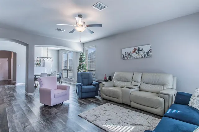 a living room with furniture and a chandelier