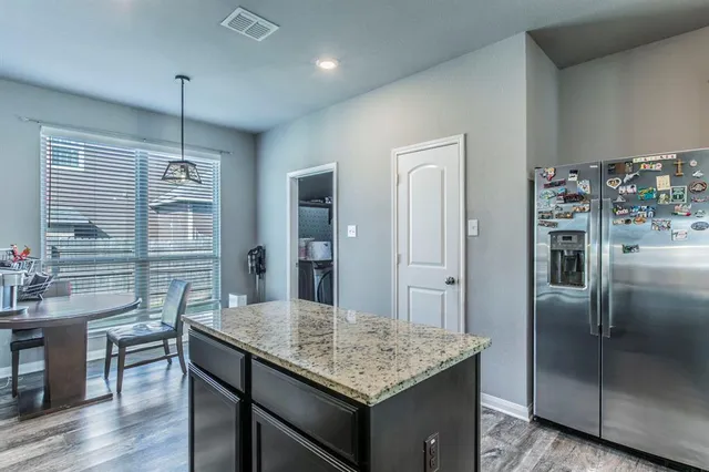 a kitchen with cabinets and refrigerator