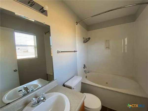 a bathroom with a toilet sink and bathtub