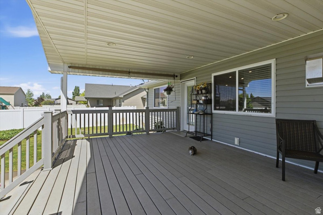 772 East 600 South Preston, ID 83263 - Photo 28 of 35 Expansive covered deck featuring a textured composite surface, white railing, recessed lighting, and direct access to interior via a glass-paneled door