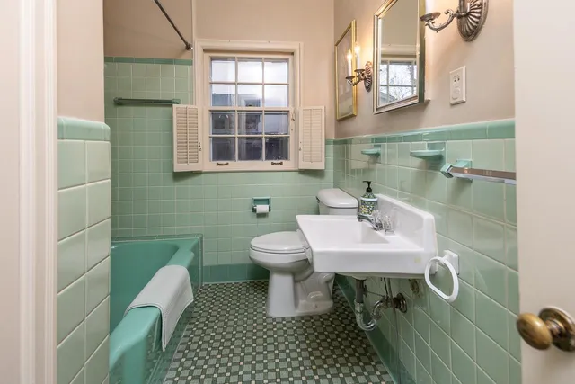 a bathroom with a sink a toilet and mirror