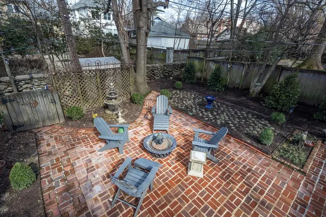 a wooden bench sitting in backside of a house