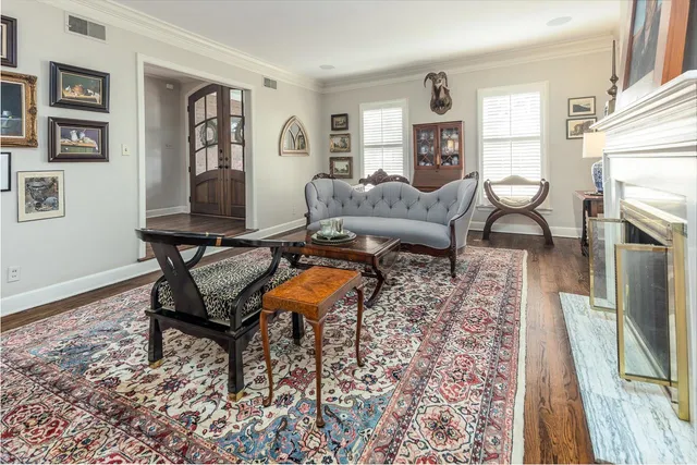 a living room with furniture a fireplace and a flat screen tv