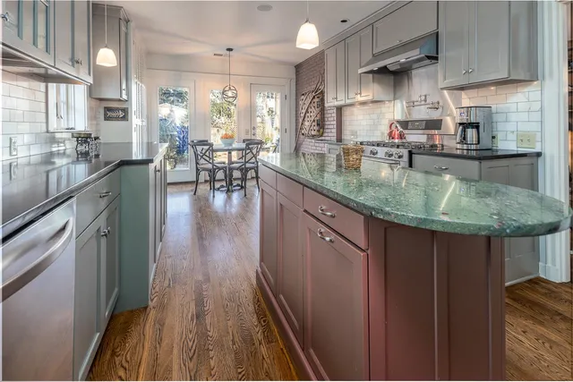 a kitchen with counter top space a sink appliances and cabinets