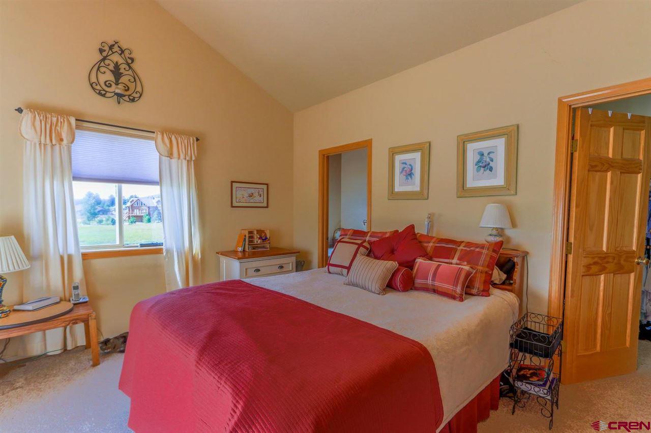 75 Pebble Circle Pagosa Springs, CO 81147 - Photo 13 of 30 a bedroom with a bed and a window