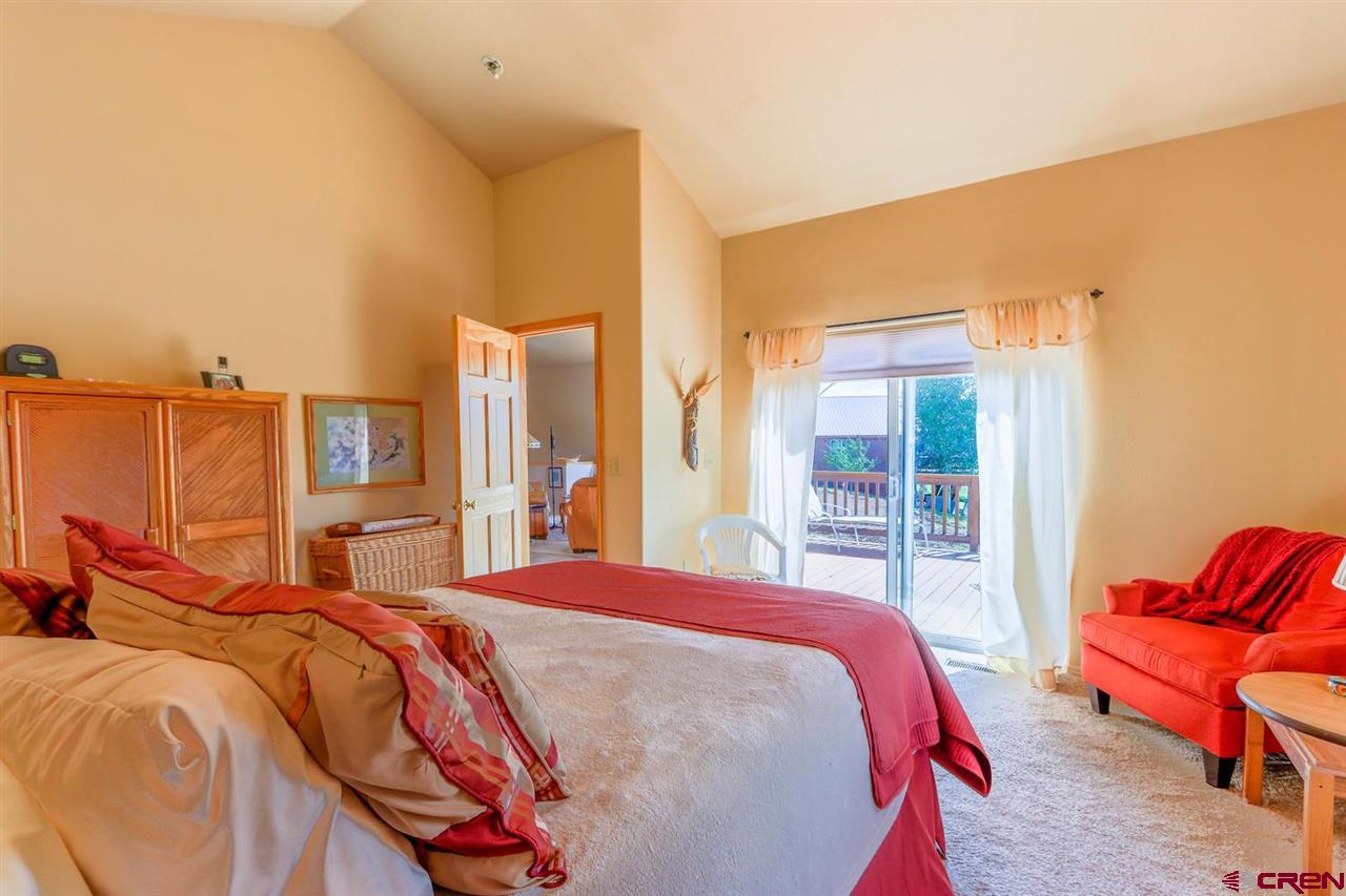 75 Pebble Circle Pagosa Springs, CO 81147 - Photo 14 of 30 a bedroom with a bed and glass window