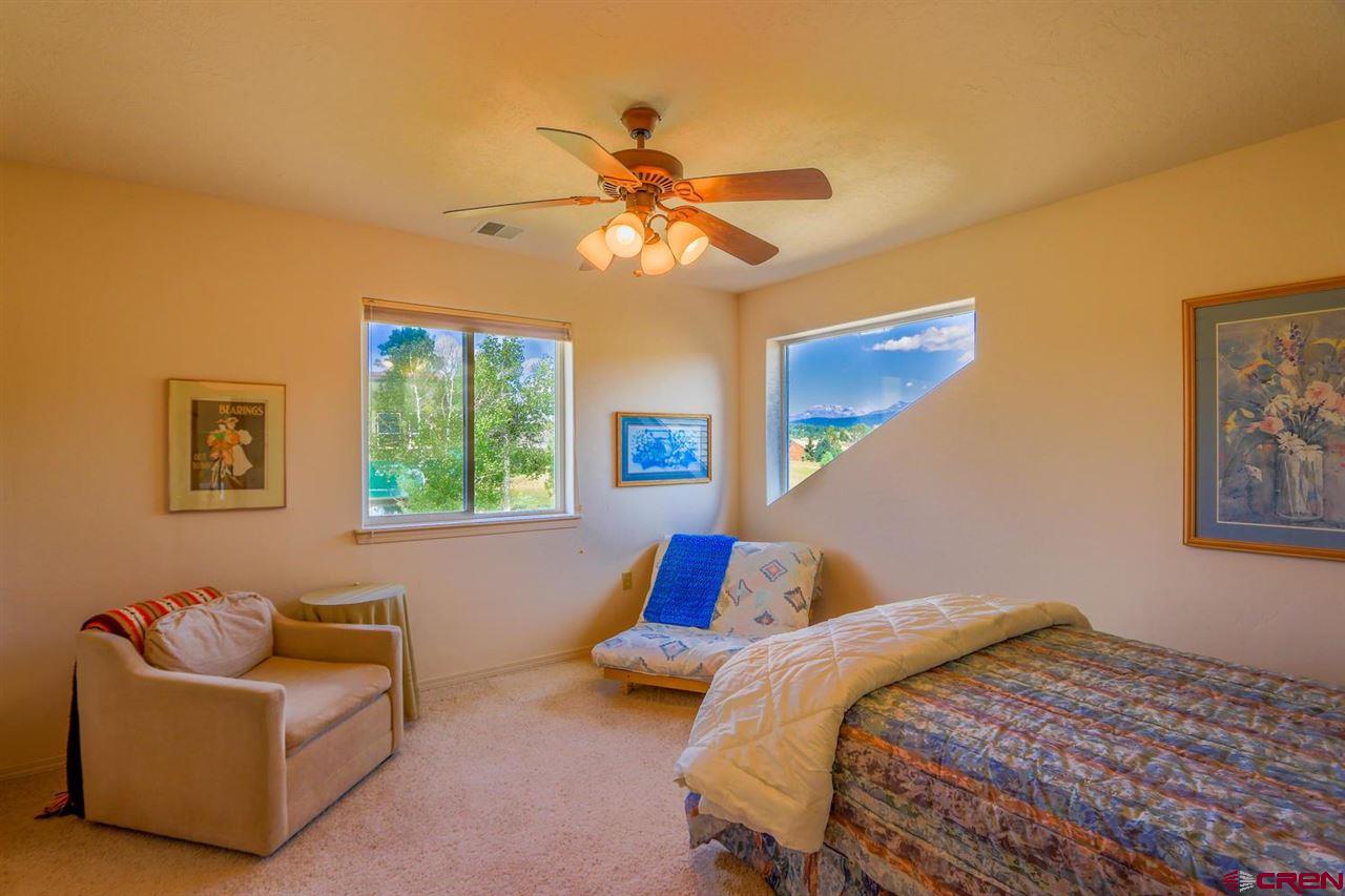 75 Pebble Circle Pagosa Springs, CO 81147 - Photo 17 of 30 a bedroom with a bed and a couch
